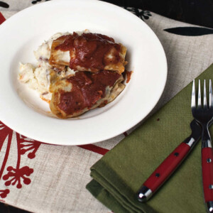 Lasagna with cabbage rolls on a plate.