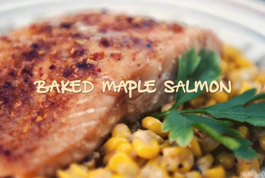 Close up of salmon glazed with maple on a plate with corn.