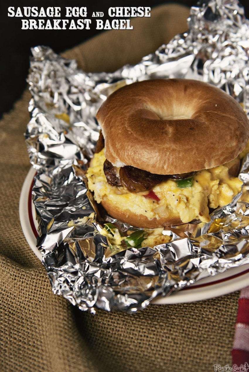 bagel with scrambled eggs and sausage in aluminium foil.