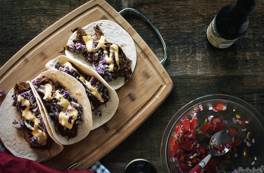 BBQ Brisket Tacos with Dubliner Cheese Sauce on a cutting board