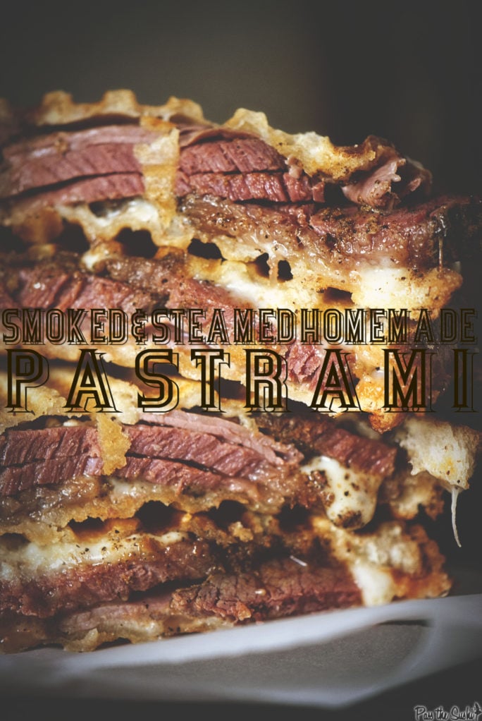 Smoked and Steamed pastrami sandwich sliced in half and stacked to expose thick cuts of meat