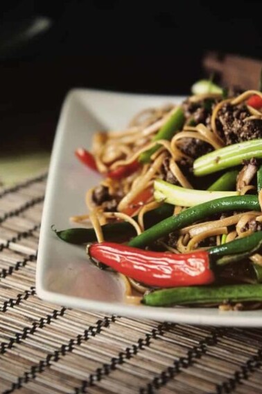 Szechuan beef noodles with green beans.