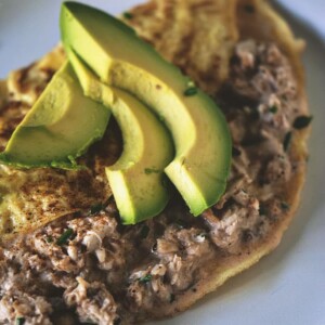 A crab omelet featuring avocado, served on a plate.