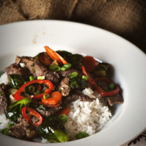 A plate with beef stir fry and vegetables.