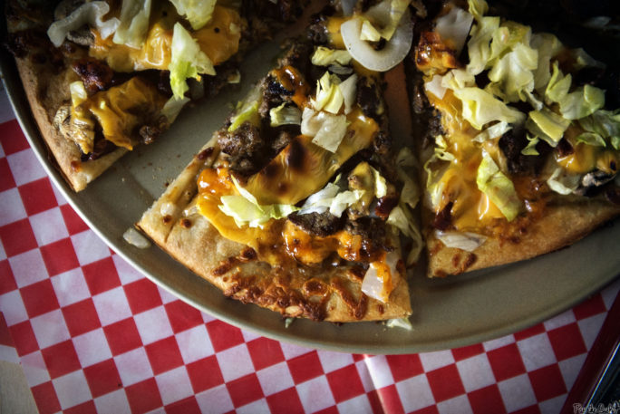 Cheeseburger Pizza. Burger chunks, cheese, lettuce and onions, all on a pizza crust. So good.