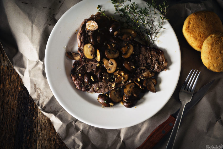 a Grilled T-Bone Steak smothered in mushrooms. A sprig of thyme, and some corn biscuits. Yeah, that's a hearty dinner.