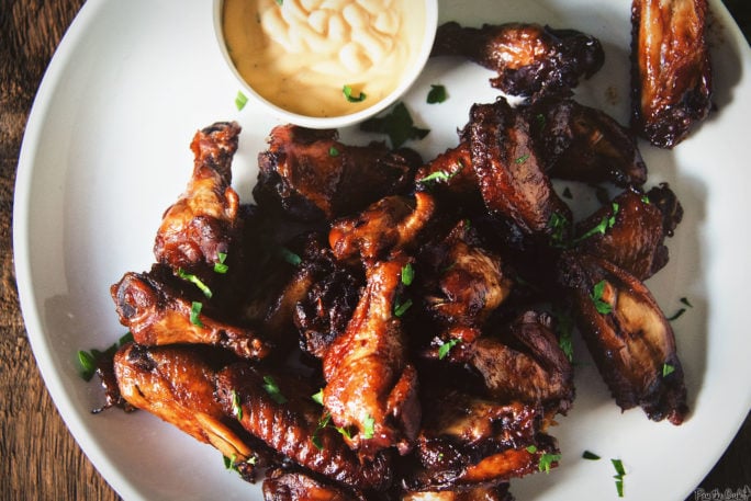 A pile of delicious Chicken Wings sprinkled with parsley.