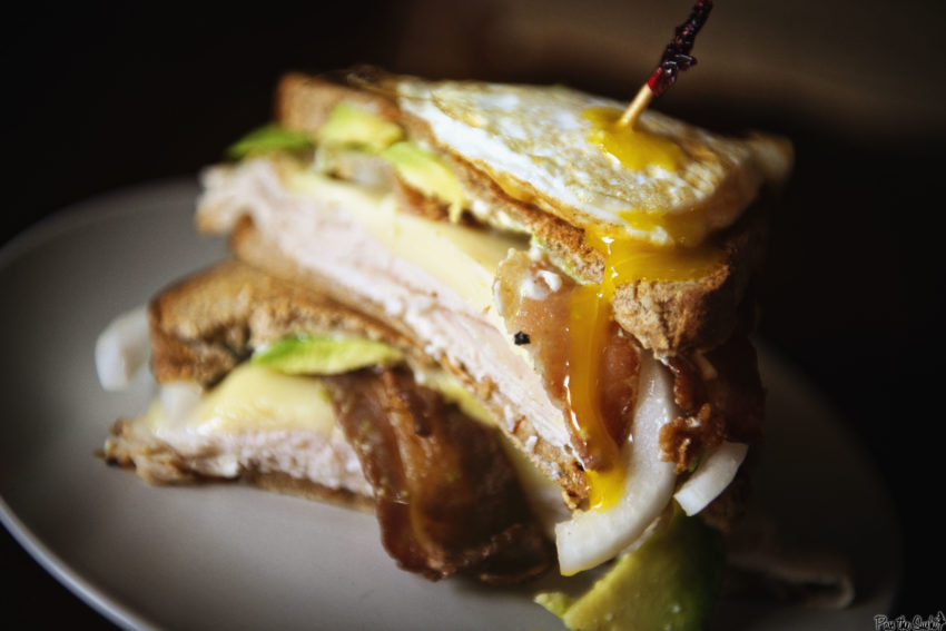 This sandwich is filled to overflowing with turkey, bacon, avocado, and onions. Then to top it off, a fried egg. This isn't your school box turkey sandwich!