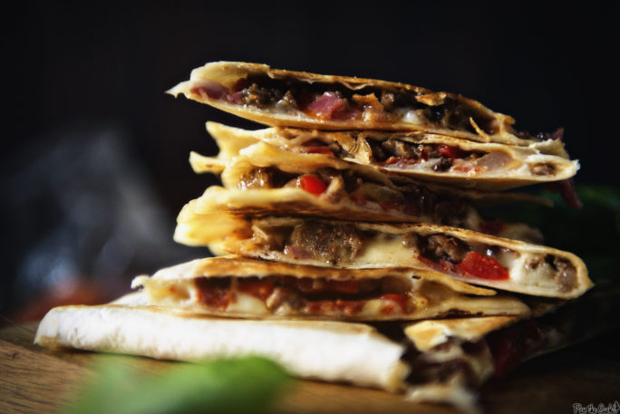 A stack of meat filled quesadilla slices. So much meat!