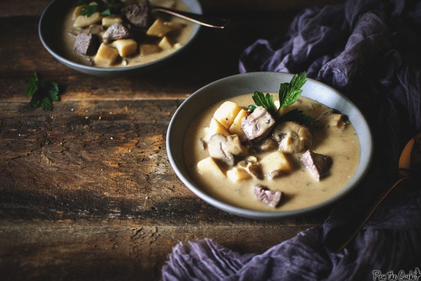 Creamy potato soup in thick beef broth with bites of steak