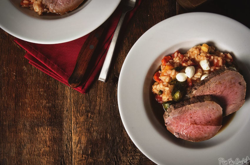 Dish of fall risotto and two slices of perfectly cooked eye of round roast