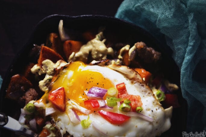 This sunny side up egg is just oozing goodness into a pile of sweet potatoes and sausage. This breakfast hash is legit fuel for your day!