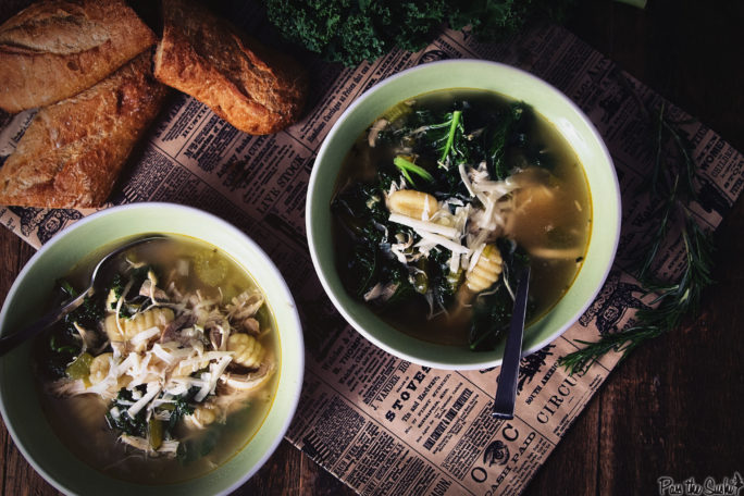 Two bowls of Chicken, Gnocchi and Kale Soup with a split baguette to add some crunch.