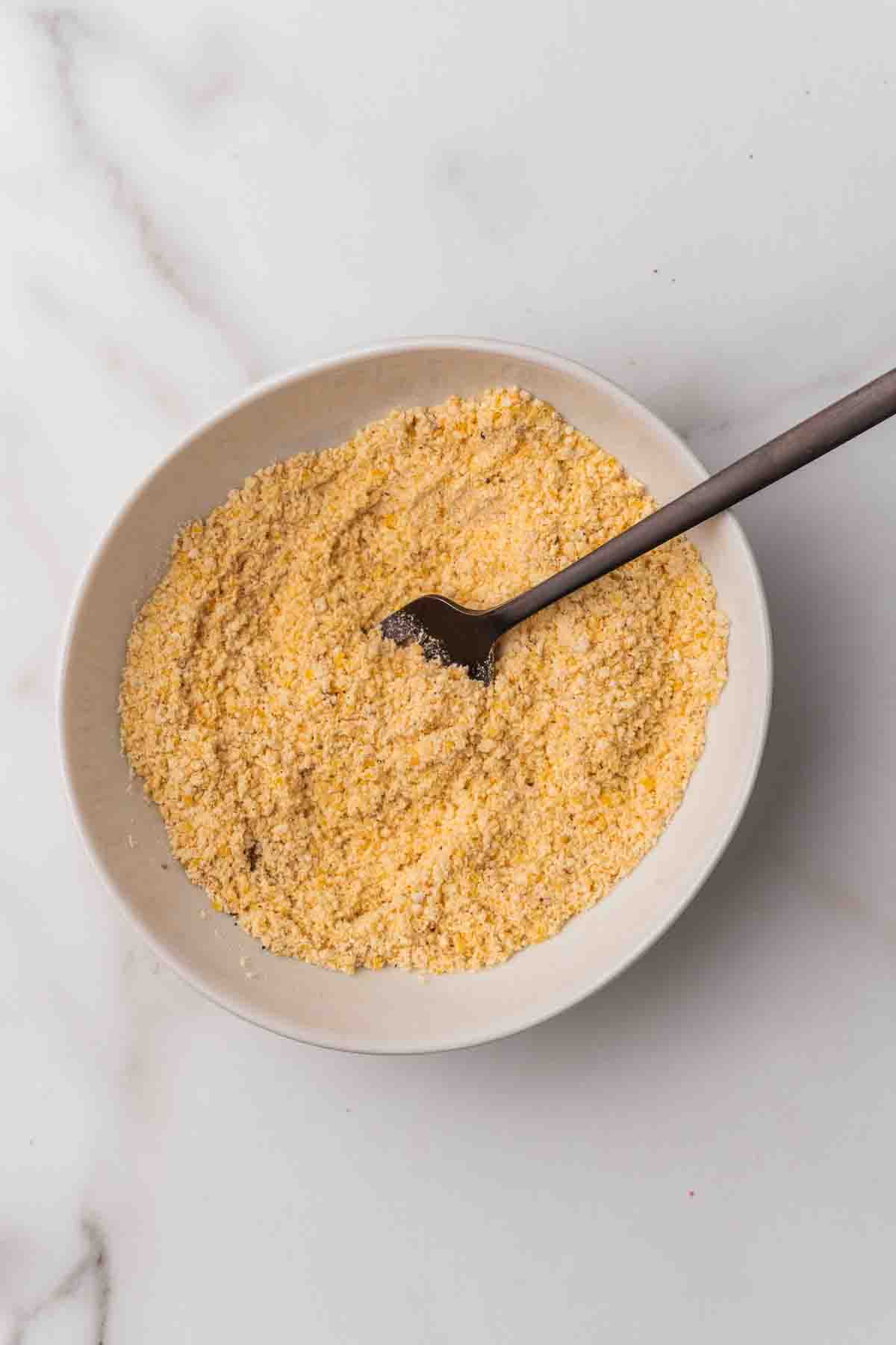 Cornmeal in a white bowl.