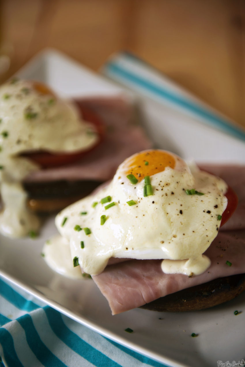 A perfectly poached egg sitting atop ham and english muffin. A sour cream hollandaise substitute takes this recipe from a complicated affair to on the table in minutes.