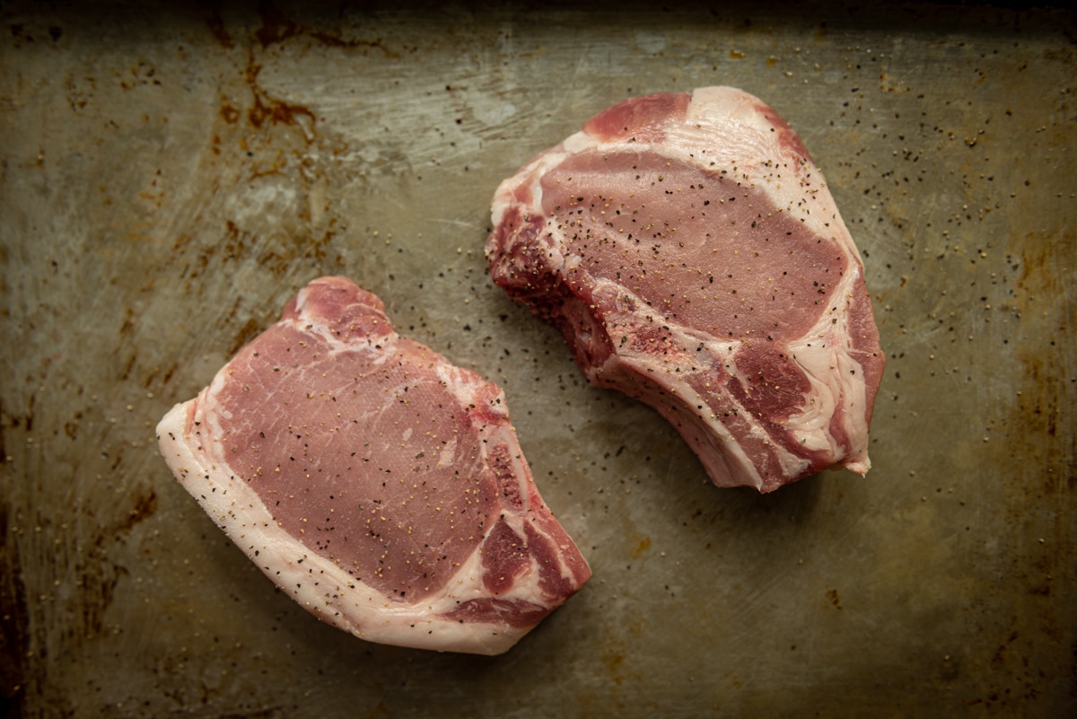 thick cut bone in pork chops ready to be grilled