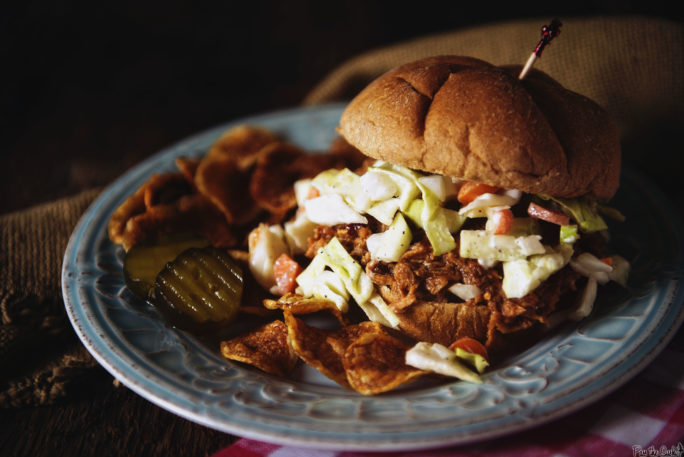 Pulled pork and coleslaw are pouring out of ta wheat roll, overtaking the pickles and chips. You're gonna want to make this one!
