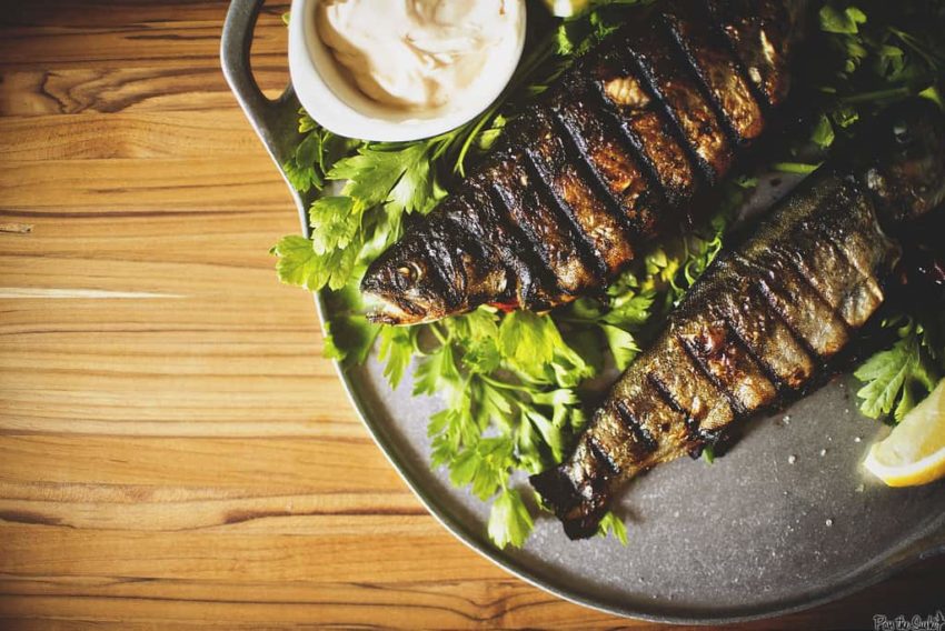Rainbow trout stuffed with herbs grilled with crisped skin.