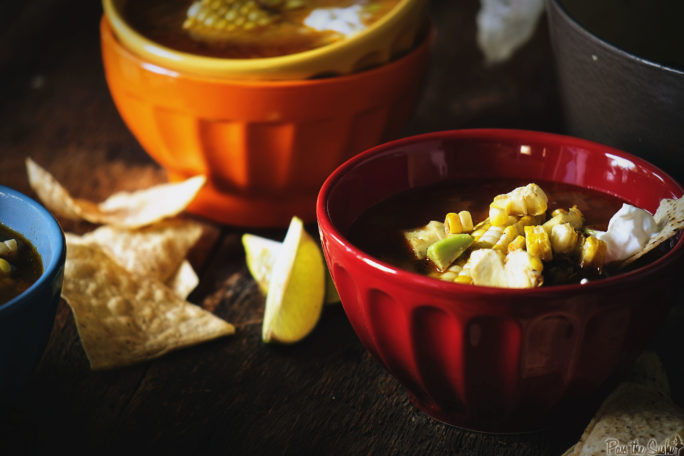 Colorful bowls filled with Grilled Chicken Tequila Tortilla Soup. Extra chips optional.