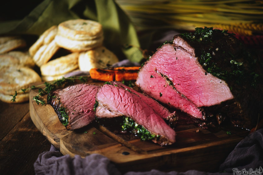 Roast beef sliced to show red juicy center. 