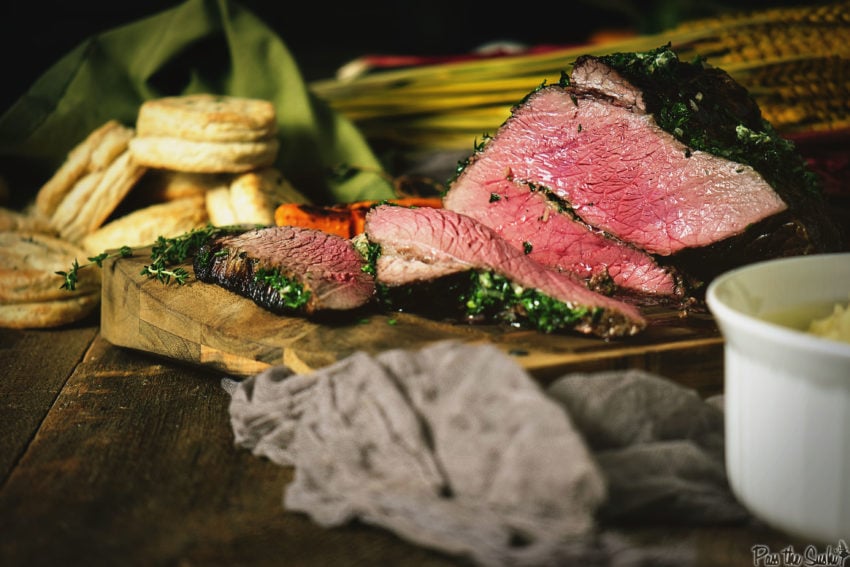 Juicy top round roast cooked and sliced on a table. 