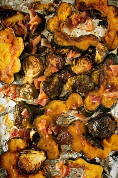 Roasted Brussels sprouts and bacon on tin foil.