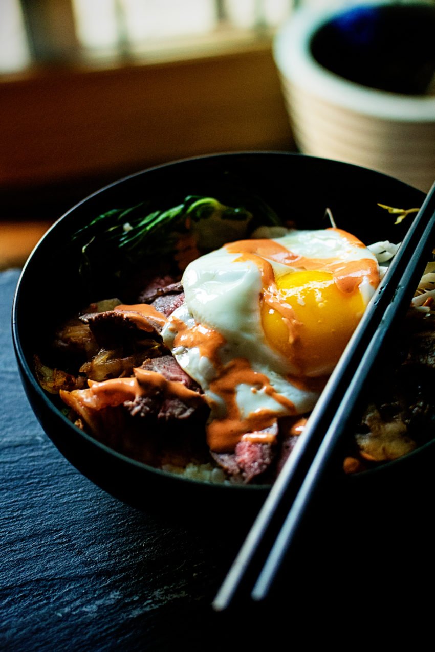 This bowl is filled with a pile of veggies, grilled steak, and topped with a sunny side up egg. Yeah, This is gonna be good!