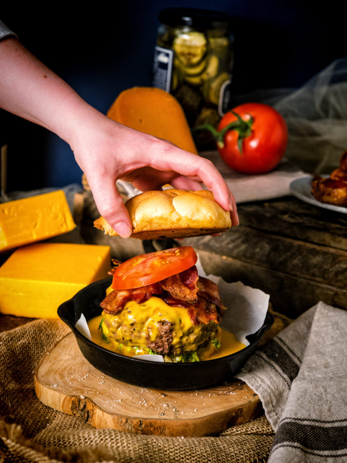 Sitting in it's own skillet to contain the cheese avalanche, this burger is ready to serve!