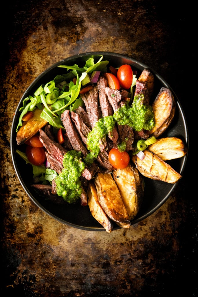 Chimichurri smothering rare Steak, Potatoes, and greens. Yeah, this bowl is packed with power.