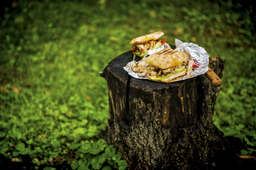 Chicken Panini in foil on a stump with knife | Kita Roberts GirlCarnivore.com
