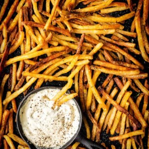 A bowl of french fries served with a scoop of dipping sauce, inspired by Steak Frites.