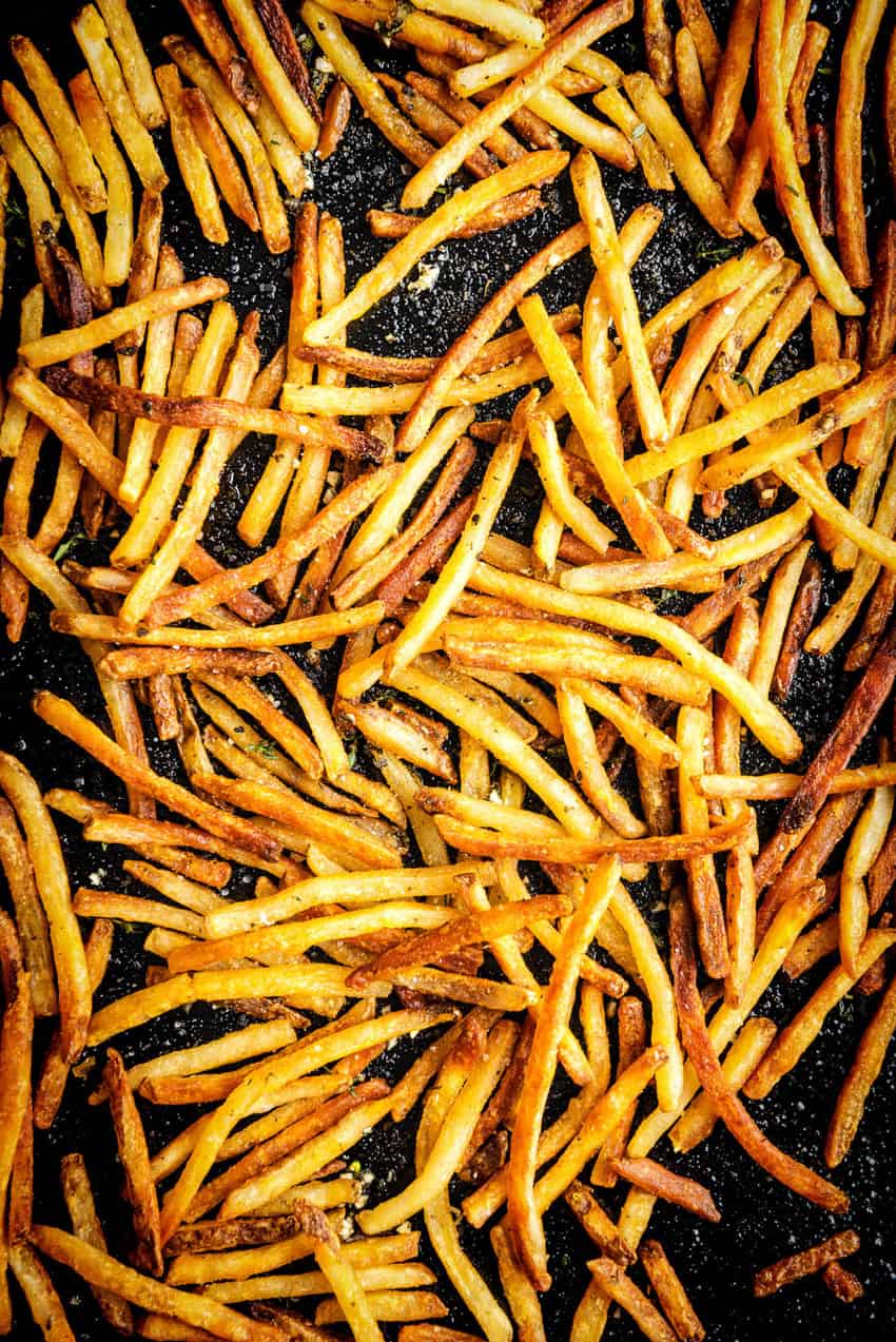 Baking sheet loaded with golden brown crispy fries.