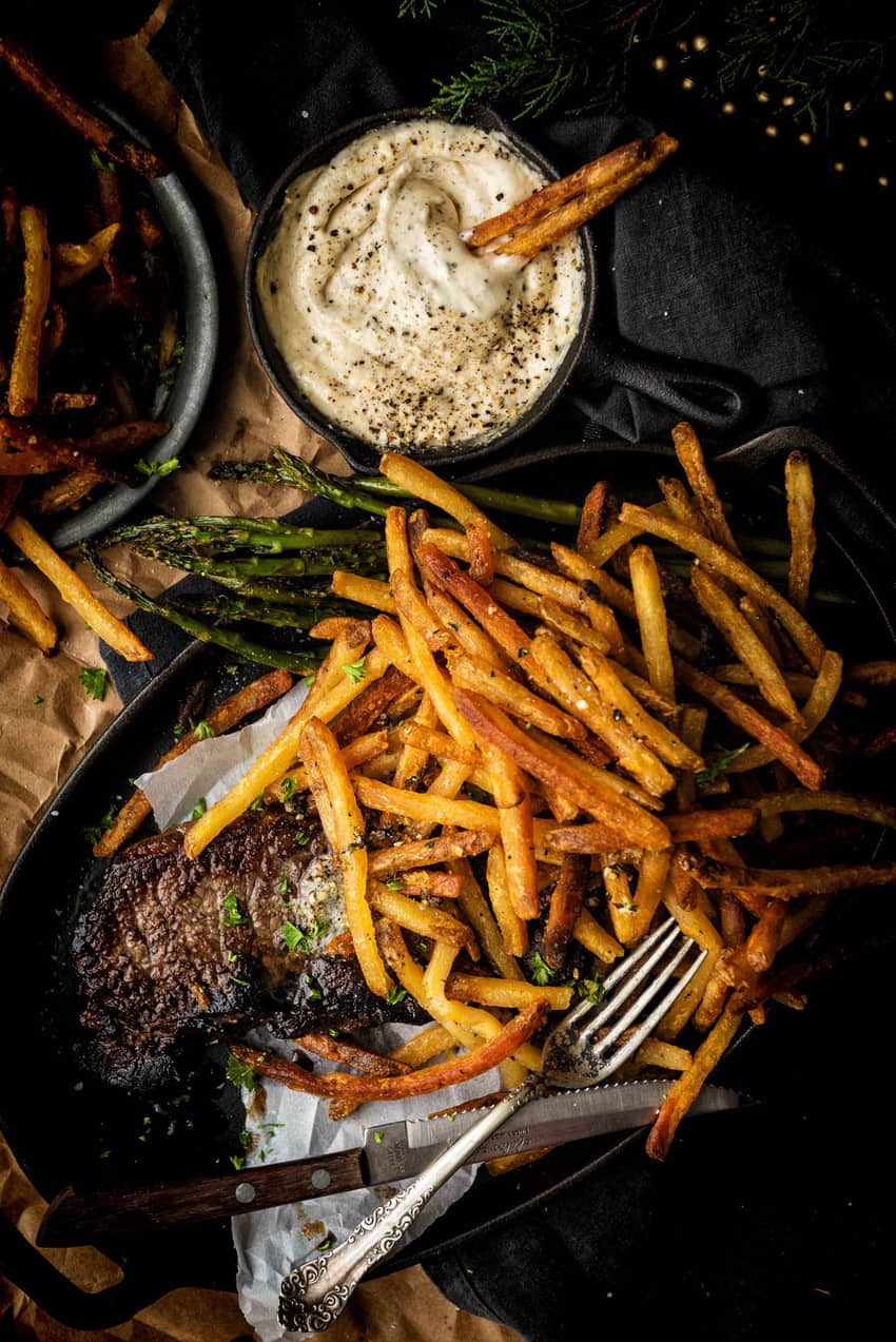 This enormous pile of fries on top of this steak may look like a side, but they're fried in duck fat. so you're gonna want to eat every last one!