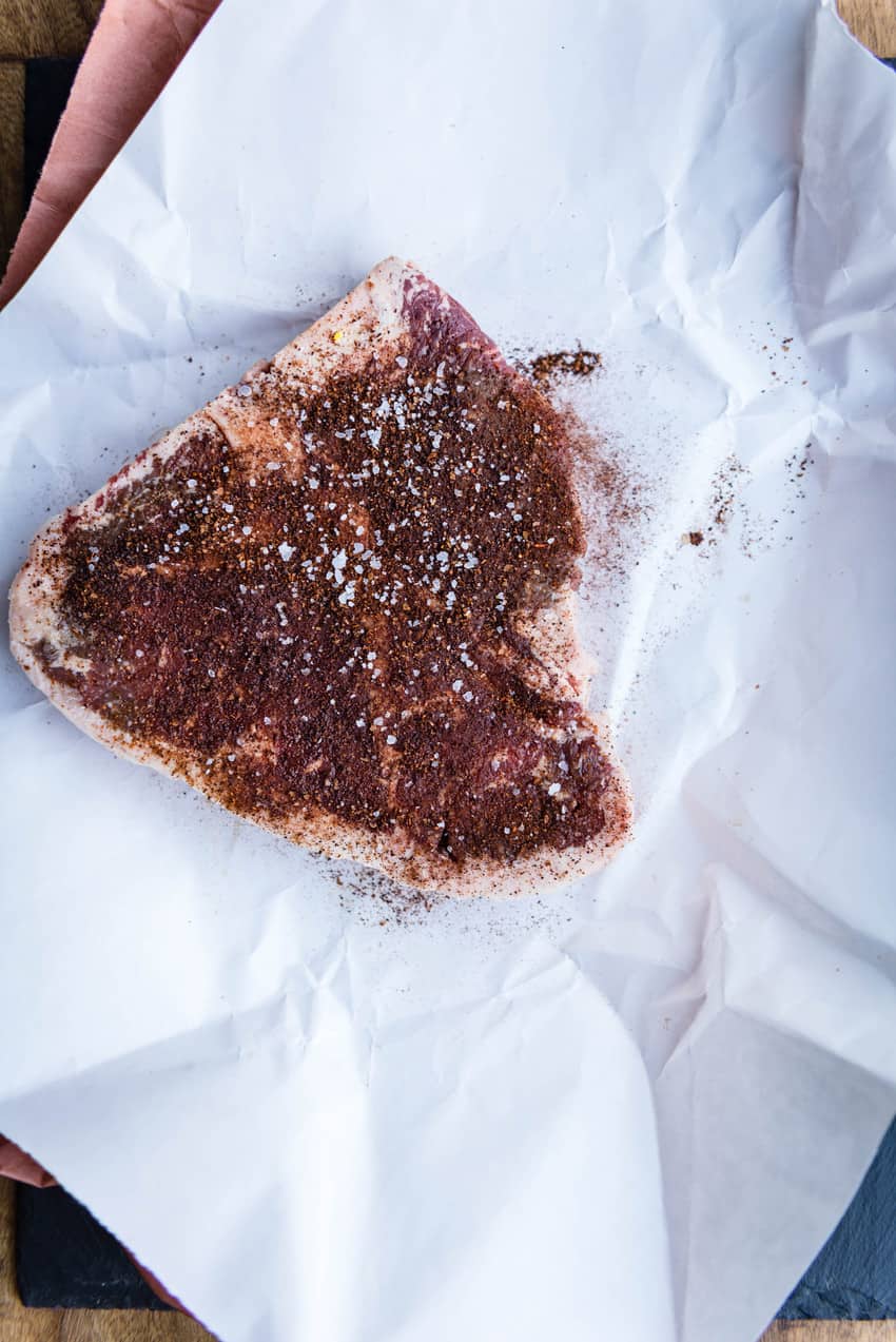 T-bone steak thats been rubbed with spices and salt. 