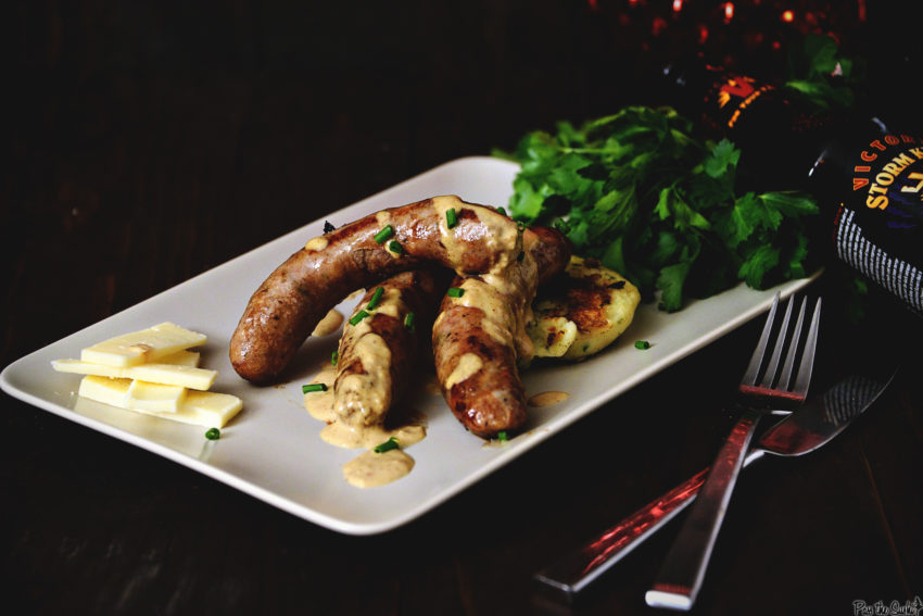Lightly browned Irish Sausage perched atop potato cakes, hunks of cheddar, and drizzled in mustard cream sauce. So good!