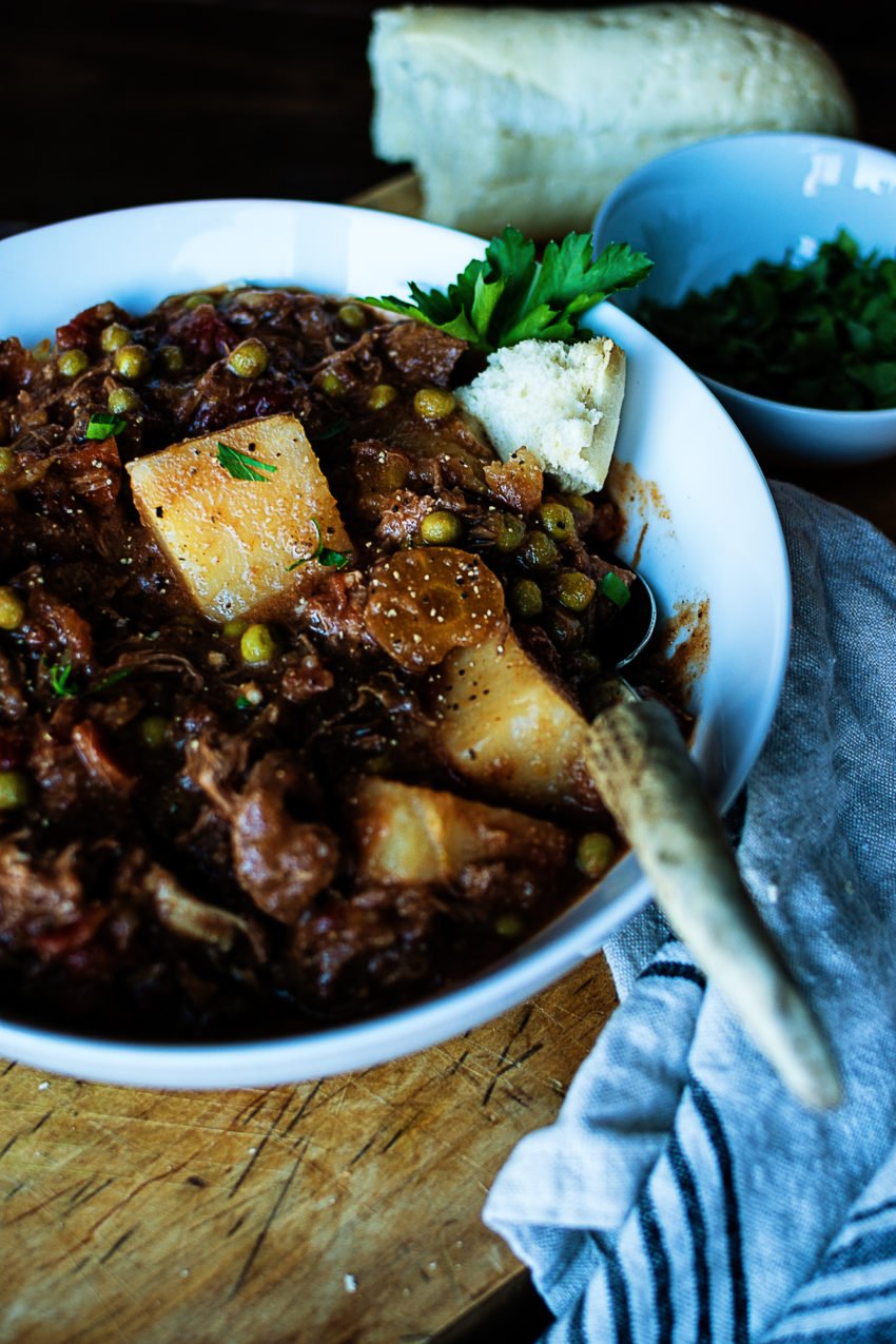 A big bowl of comforting lamb stew with potatoes and shredded slow cooked lamb