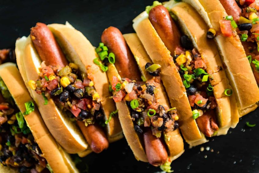 Pineapple Salsa is just piled on these hot dogs! Grab one (or three)
