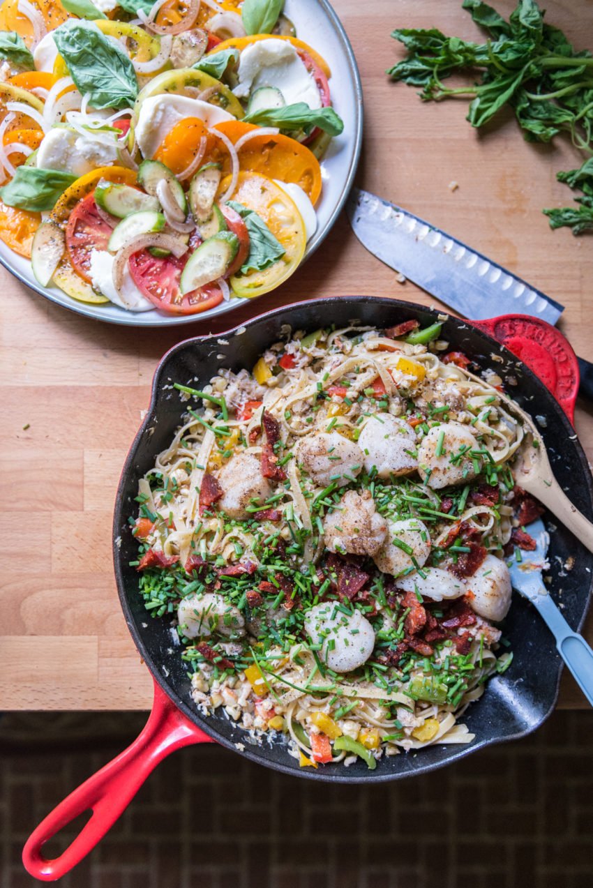 If the fresh caprese salad in the corner doesn't get you, the Summer Scallop and Crab Pasta surely will.