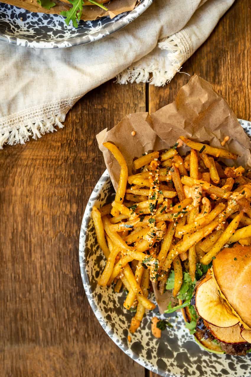 one plate packed with furikake fries on a wooden table