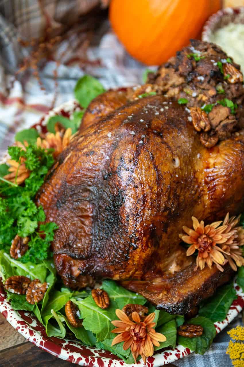 Close up of smoked turkey showing crispy golden skin on the bird and stuffing. 