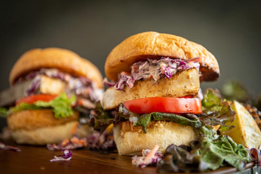 Thick swordfish steaks on buttered buns with lettuce, tomato and slaw for a huge sandwich.