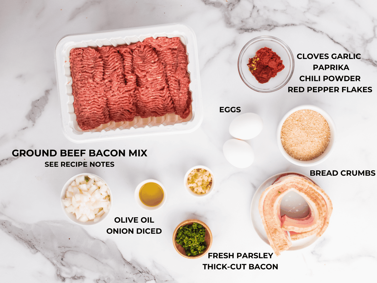 Ingredients for smoked meatloaf on white surface.