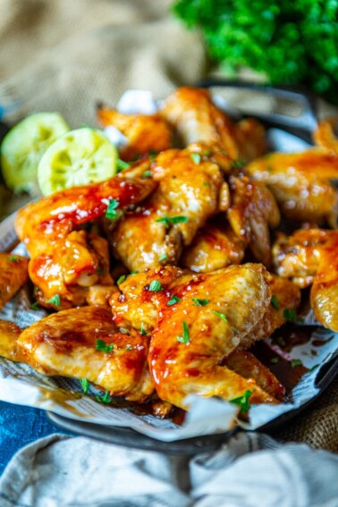 Sticky BBQ chicken wings on a plate.