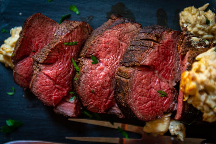 Smoked beef sliced to show medium-rare center