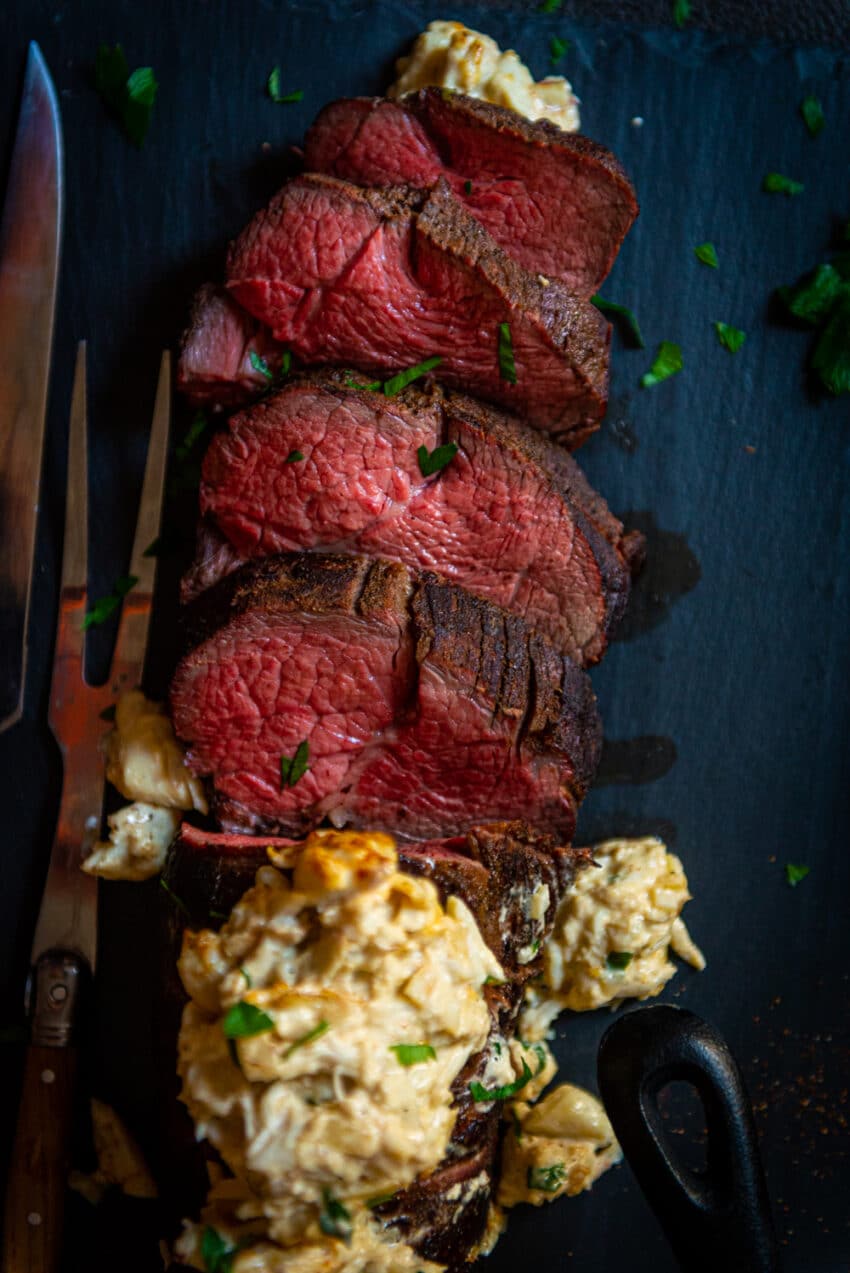 Overhead shot of sliced cooked tenderloin with a perfect edge to edge red center. 