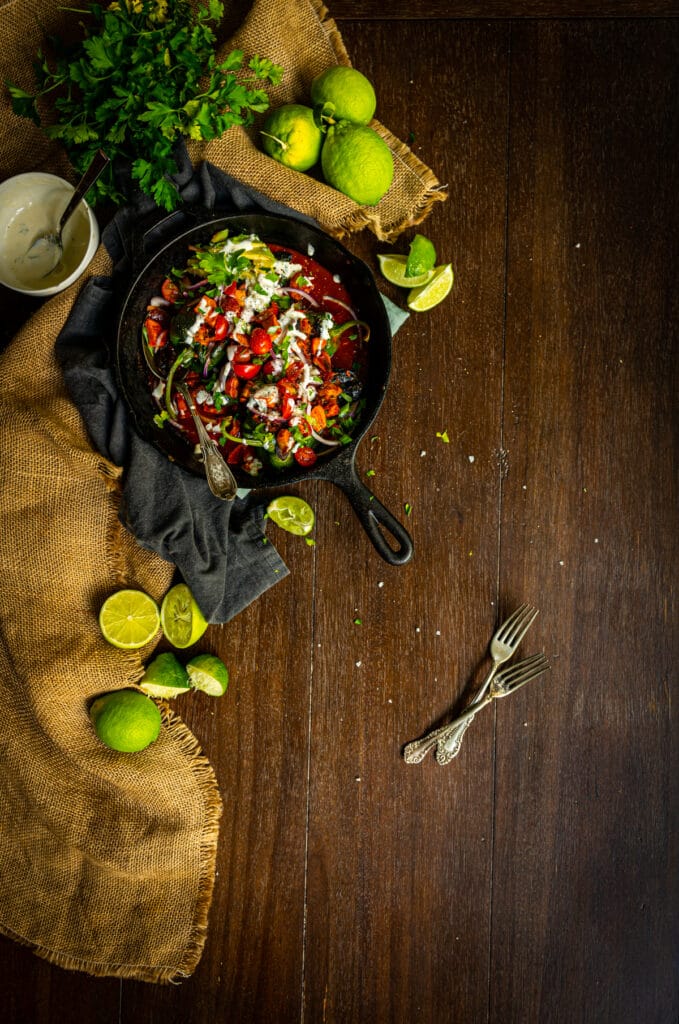 poblano peppers stuffed with chicken tinga and topped with cilantro, tomatoes, lime wedges and avocado