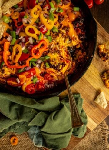 One chip for you, two chips for me! This chorizo dip is my favorite game day snack! In a skillet covered in fresh veggies for that extra pop of crunch!