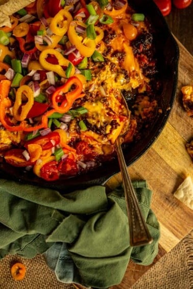 One chip for you, two chips for me! This chorizo dip is my favorite game day snack! In a skillet covered in fresh veggies for that extra pop of crunch!