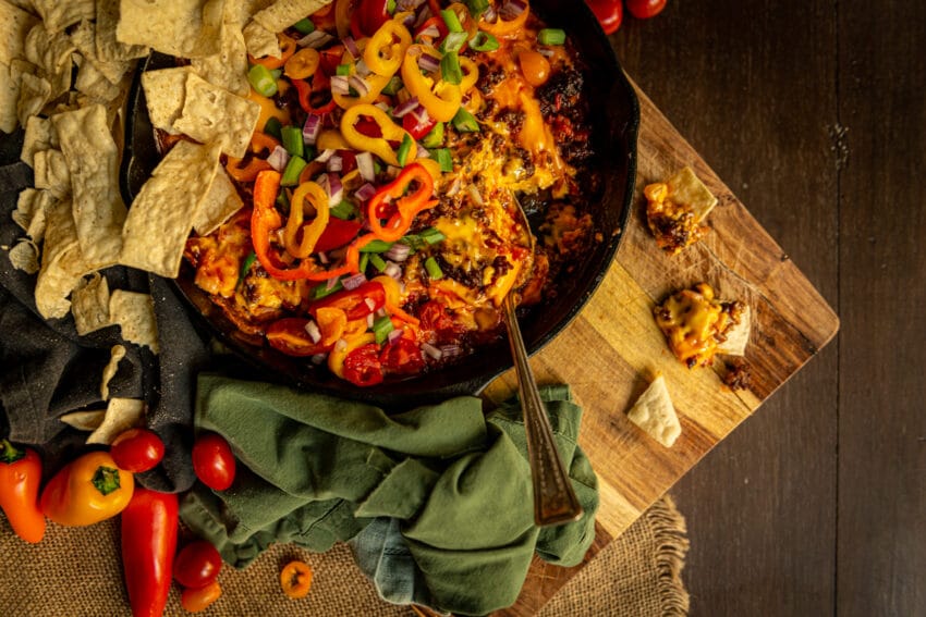 One chip for you, two chips for me! This chorizo dip is my favorite game day snack! In a skillet covered in fresh veggies for that extra pop of crunch!