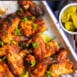 Perfectly spicy smoked chicken wings recipe that can be made on any type of grill (masterbuilt, treager, charcoal, gas, etc) with an easy buttermilk brine and spice rub